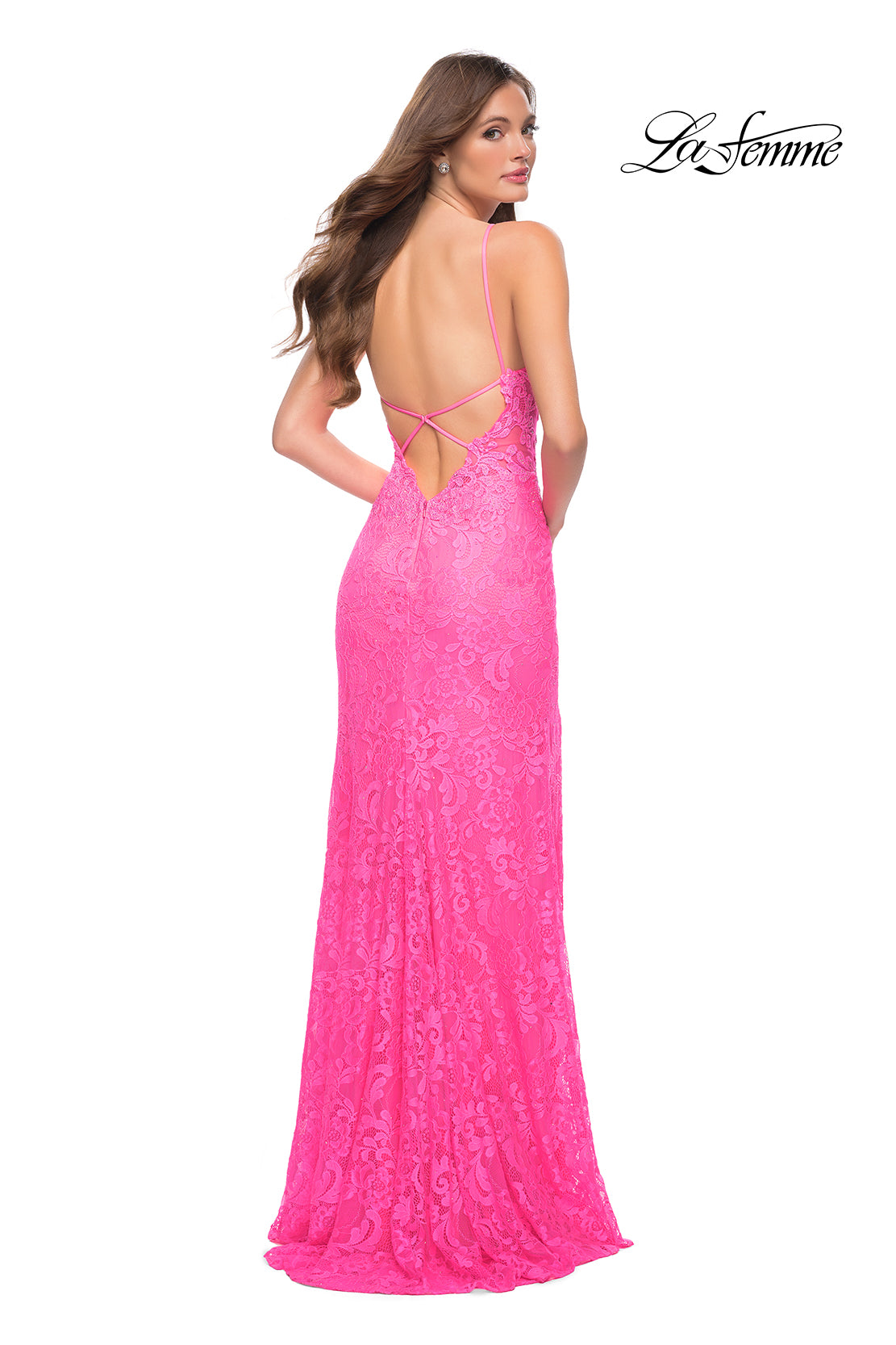 Woman in a bright pink La Femme Open-Back Long Neon Lace Prom Dress with lace details and thin straps, shown from behind. The